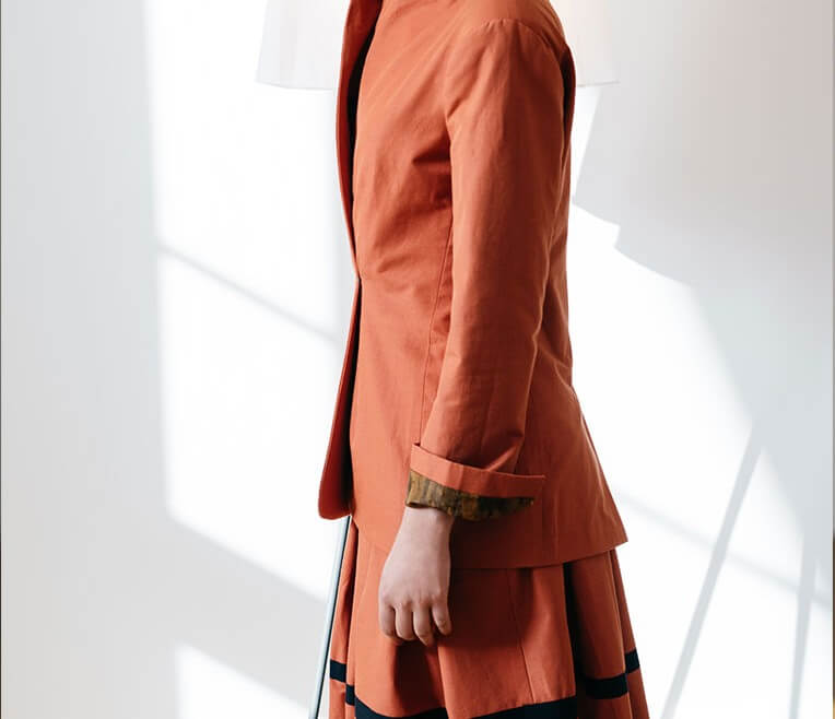 23/6 Rust-coloured plaid skirt with black trimming